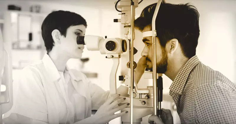 Female optician conducting eye examination on a male 