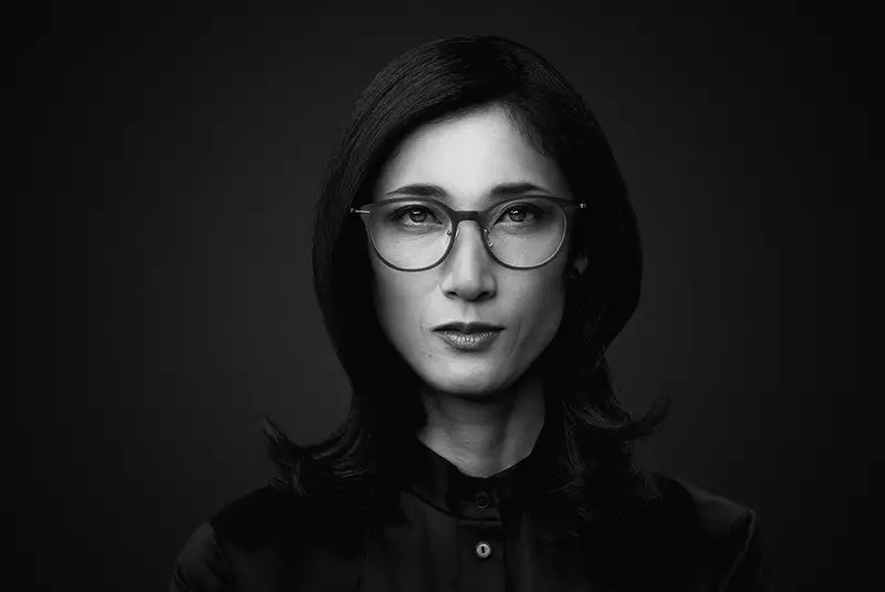 Black and white image of female wearing eyeglasses staring at the camera