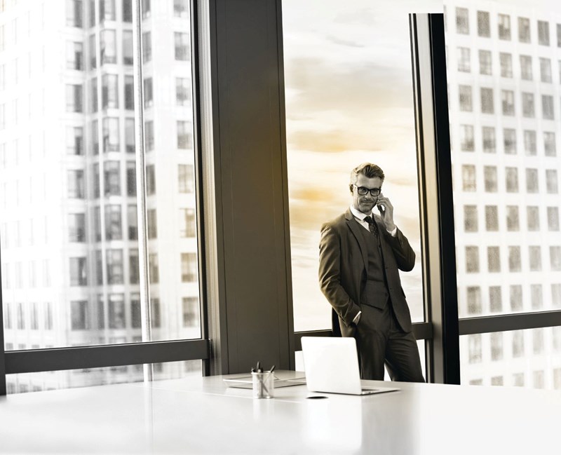 Male businessman wearing glasses on phonecall in office