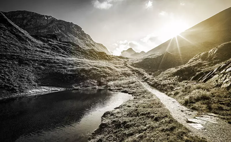 Image of mountain landscape with sun coming over the top