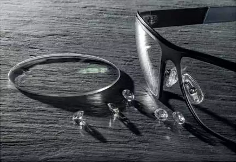 Eyeglasses on counter beside lenses