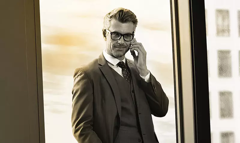 Male businessman wearing eye glasses on a phone call