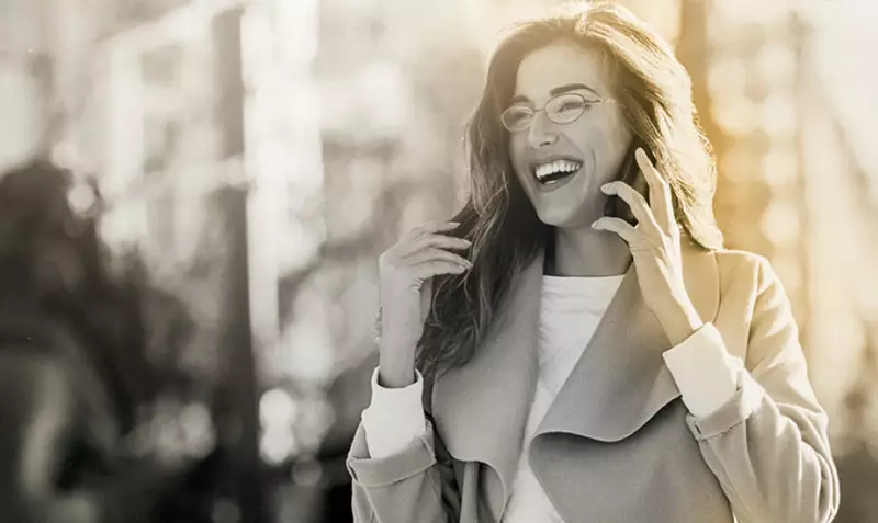 Female wearing eyeglasses on phone call smiling