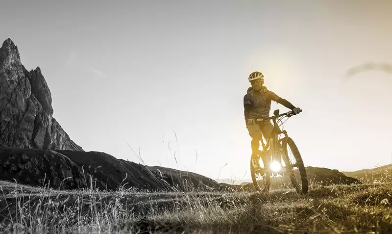 Male mountain biker on a bicycle wearing helmet