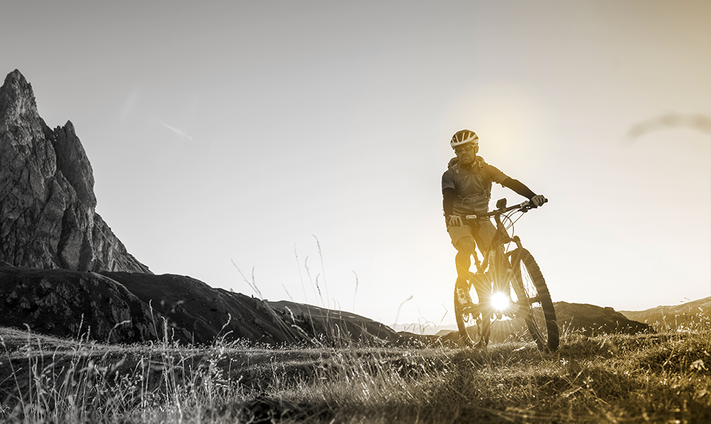 Male mountain biker on a bicycle wearing helmet