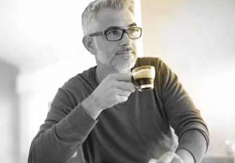 Male wearing glasses drinking coffee 