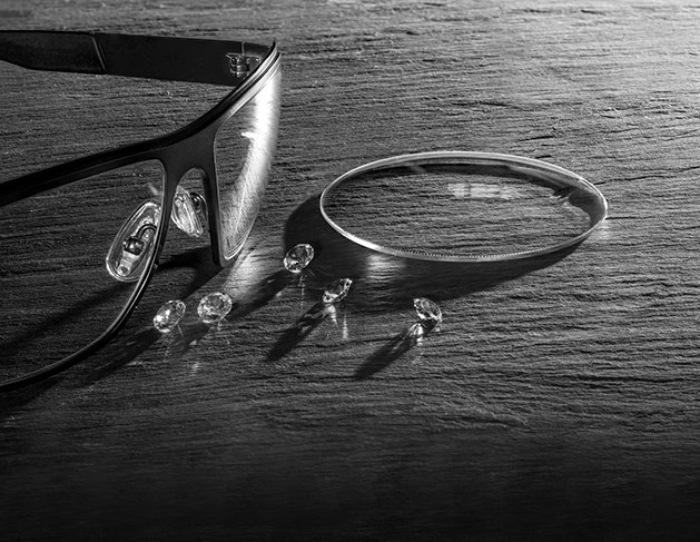 Black and white image of glasses on table with Hoya Vision lenses